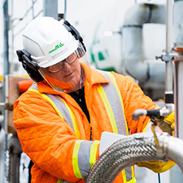 Technician performing safety check at industrial gas plant